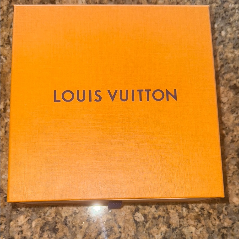 Louis Vuitton Orange Box.    It’s for a belt or small wallet